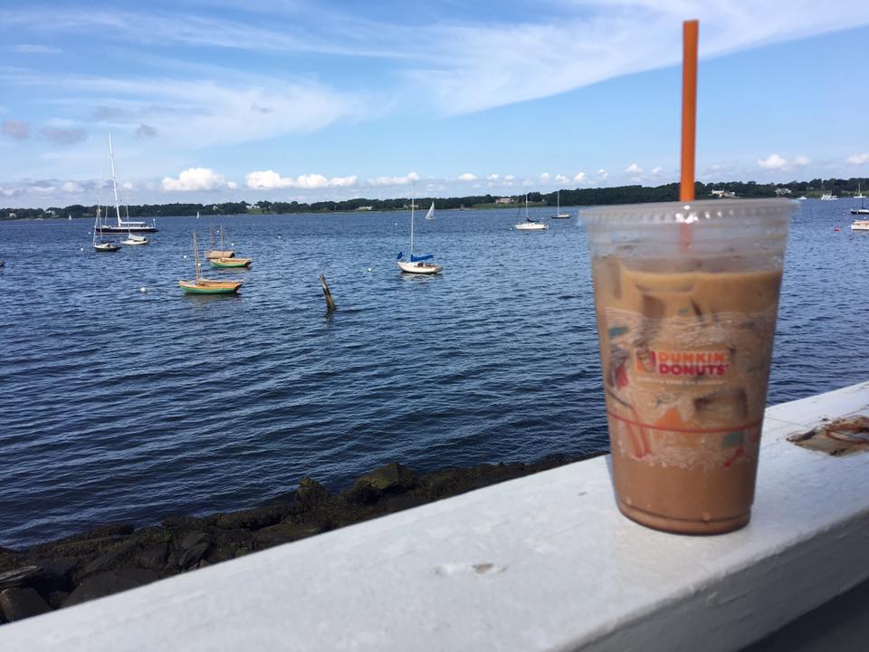 Cup of Dunkin' Donuts Iced Coffee overlooking the ocean in Providence, Rhode Island. Iced Coffee Day is May 23rd, 2018