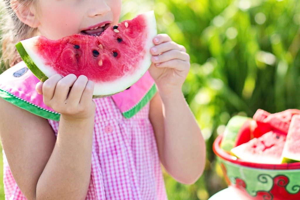 girl eating slice of watermelon Providence Moms Blog