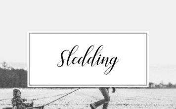 Picture of snowy background with a child being pulled on a sled and the words Sledding. Activities and things to do in Providence Rhode Island in the Winter