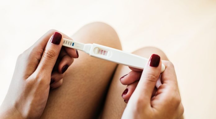 woman holding pregnancy test
