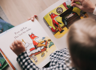 small child reading picture book