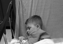 child in hospital bed after febrile seizure