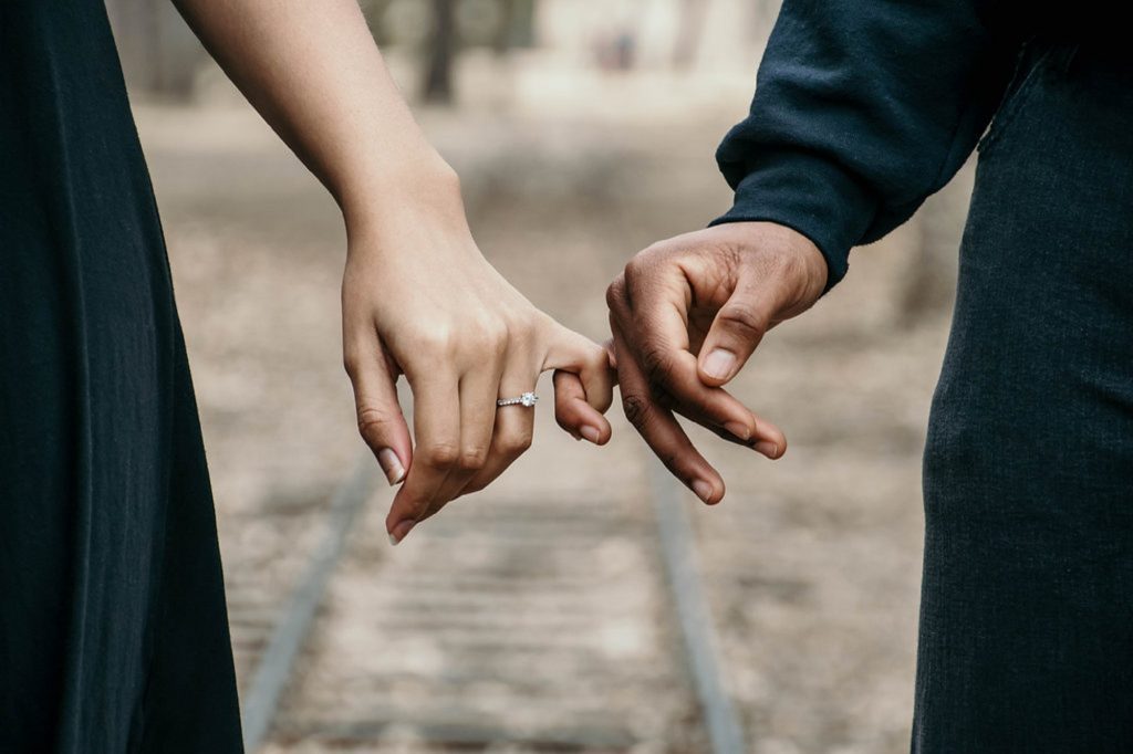 white woman and black man holding hands