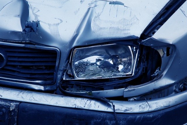 A car headlight smahed in as the result of a car accident from texting and driving
