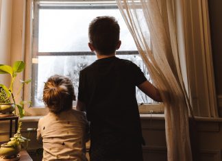 2 children looking out window