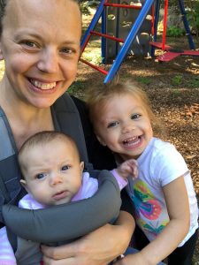 Woman smiling with baby and toddler