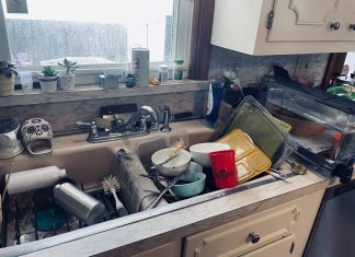 kitchen sink full of dirty dishes